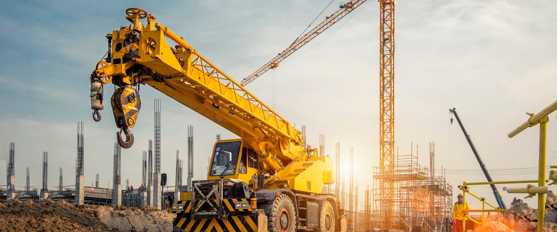 Mobile Crane on a road and tower crane in construction site